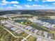 Community aerial view showing the home's location within a neighborhood with lakes and green spaces at 10240 Beach Dune Dr, Englewood, FL 34223