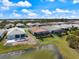 Aerial view of the home showcasing its backyard, pool, and proximity to a lake at 10240 Beach Dune Dr, Englewood, FL 34223