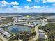 Overhead view showcasing the neighborhood layout with multiple lakes, roads, and lush green surroundings at 10240 Beach Dune Dr, Englewood, FL 34223