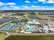 Aerial view showcases community amenities: clubhouse, pool, tennis and pickleball courts, surrounded by residences at 10240 Beach Dune Dr, Englewood, FL 34223