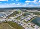 An aerial view displaying a large planned community featuring lakes, roads, and homes amongst nature at 10240 Beach Dune Dr, Englewood, FL 34223