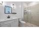 Bright bathroom featuring white vanity with black faucet and a modern glass shower at 10240 Beach Dune Dr, Englewood, FL 34223