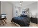 Bedroom featuring a decorative black and white bed set, neutral walls, and modern bedside lamps at 10240 Beach Dune Dr, Englewood, FL 34223