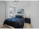Bedroom featuring a decorative black and white bed set and neutral walls at 10240 Beach Dune Dr, Englewood, FL 34223