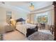 Bedroom featuring a luxurious bed, nightstands, side tables, and a decorative rug at 10240 Beach Dune Dr, Englewood, FL 34223