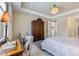 Bedroom features a chandelier, armoir, chair, and exterior entry at 10240 Beach Dune Dr, Englewood, FL 34223