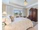 Bedroom featuring a luxurious bed, chandelier, window, and a decorative rug at 10240 Beach Dune Dr, Englewood, FL 34223