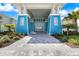 Stunning clubhouse entrance with striking blue accents and lush landscaping, creating an inviting and upscale atmosphere at 10240 Beach Dune Dr, Englewood, FL 34223