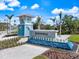 Inviting entrance to Beachwalk by Manasota Key, adorned with a water feature and lush green landscaping at 10240 Beach Dune Dr, Englewood, FL 34223