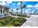 Stunning resort-style pool area with palm trees, lounge chairs, and ample seating for residents to enjoy at 10240 Beach Dune Dr, Englewood, FL 34223
