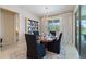Dining room showcases a wood table, chairs, decorative shelving, and a view of the outdoors at 10240 Beach Dune Dr, Englewood, FL 34223