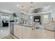 Open-concept kitchen features a central island with granite countertops and stainless-steel appliances at 10240 Beach Dune Dr, Englewood, FL 34223