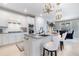 Bright kitchen boasts granite countertops, stainless appliances, and a breakfast bar with stylish pendant lighting at 10240 Beach Dune Dr, Englewood, FL 34223
