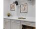 Modern laundry room with ample counter space, white cabinets, and elegant gold hardware at 10240 Beach Dune Dr, Englewood, FL 34223
