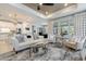 Spacious living room featuring stylish furniture, modern decor, and a seamless flow to the kitchen at 10240 Beach Dune Dr, Englewood, FL 34223