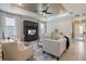 Bright living room with elegant furniture, ceiling fan, and neutral decor at 10240 Beach Dune Dr, Englewood, FL 34223