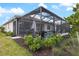 Screened-in lanai with covered patio, pool, and lush landscaping creates a private backyard retreat at 10240 Beach Dune Dr, Englewood, FL 34223