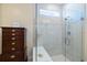 Modern glass shower with a built-in bench and view of the luxurious tile work at 10240 Beach Dune Dr, Englewood, FL 34223