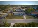 This is a high-angle aerial view that captures a well-kept single-story home and a sprawling, vibrant green lawn at 106 65Th Avenue W Dr, Bradenton, FL 34207