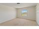 This spacious bedroom features neutral walls and carpet, along with a bright window at 11212 58Th Street E Cir, Parrish, FL 34219