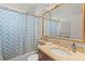 Bathroom showcasing vanity with a stone countertop and a tub with a shower and curtain at 12710 Rockrose Gln, Lakewood Ranch, FL 34202