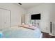 Bedroom featuring white trim and wainscoting, a large window, and a comfortable bed at 12710 Rockrose Gln, Lakewood Ranch, FL 34202