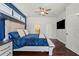 Spacious bedroom with ceiling fan, hardwood floors, and adjacent bathroom and walk-in closet at 12710 Rockrose Gln, Lakewood Ranch, FL 34202