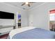 Bright bedroom featuring a ceiling fan, hardwood floors, and open doorway at 12710 Rockrose Gln, Lakewood Ranch, FL 34202