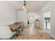 Bright dining room with stylish lighting, long table, and seamless flow into the adjacent office at 12710 Rockrose Gln, Lakewood Ranch, FL 34202