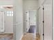 Hallway featuring neutral paint, white trim and doors and a view of the home's entry and front door at 12710 Rockrose Gln, Lakewood Ranch, FL 34202