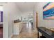 Bright hallway with tiled floors, elegant decor, and views into the dining and kitchen areas at 12710 Rockrose Gln, Lakewood Ranch, FL 34202