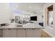 Bright and modern kitchen featuring white cabinets, stainless steel appliances, and a spacious island at 12710 Rockrose Gln, Lakewood Ranch, FL 34202