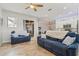 Inviting living room with tile floors and comfortable blue sofas at 12710 Rockrose Gln, Lakewood Ranch, FL 34202