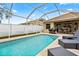 Inviting screened-in pool with lounge chairs and outdoor dining area at 12710 Rockrose Gln, Lakewood Ranch, FL 34202