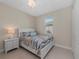 Cozy bedroom featuring a white bed frame, tile floor, and a ceiling fan for added comfort at 12726 Rainwashed Loop, Parrish, FL 34219