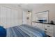 Bright bedroom featuring a white dresser, mirror, tile floor, a window, and a closet at 12726 Rainwashed Loop, Parrish, FL 34219