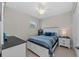 Cozy bedroom featuring a white bed frame, tile floor, and a ceiling fan for added comfort at 12726 Rainwashed Loop, Parrish, FL 34219