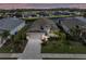 Charming single-story home with manicured landscaping, a two-car garage, and a view of the serene community lake at 12726 Rainwashed Loop, Parrish, FL 34219