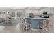 Bright kitchen featuring stainless appliances, a breakfast bar, and seamlessly connects with the dining and living area at 12726 Rainwashed Loop, Parrish, FL 34219