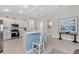 Modern kitchen with stainless steel appliances, breakfast bar, and open to living area; perfect for entertaining guests at 12726 Rainwashed Loop, Parrish, FL 34219