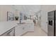 Contemporary kitchen with stainless steel appliances, sleek countertops, and seamless integration with the dining area at 12726 Rainwashed Loop, Parrish, FL 34219