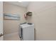 Well-equipped laundry room with washer, dryer, and shelving for convenient storage at 12726 Rainwashed Loop, Parrish, FL 34219
