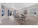 Bright living room with vaulted ceilings, tile flooring, and sliding glass doors to the lanai at 12726 Rainwashed Loop, Parrish, FL 34219