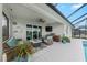 Relaxing outdoor patio featuring wicker seating, ceiling fan, and summer kitchen with built-in grill at 12726 Rainwashed Loop, Parrish, FL 34219