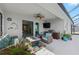 Relaxing outdoor patio featuring wicker seating, ceiling fan, and summer kitchen with built-in grill at 12726 Rainwashed Loop, Parrish, FL 34219