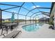 A refreshing screened-in pool offers a relaxing outdoor space with picturesque lake views at 12726 Rainwashed Loop, Parrish, FL 34219