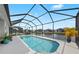 A refreshing screened-in pool offers a relaxing outdoor space with picturesque lake views at 12726 Rainwashed Loop, Parrish, FL 34219
