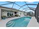 A refreshing screened-in pool offers a relaxing outdoor space with picturesque lake views at 12726 Rainwashed Loop, Parrish, FL 34219