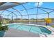 A refreshing screened-in pool offers a relaxing outdoor space with picturesque lake views at 12726 Rainwashed Loop, Parrish, FL 34219