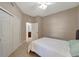 Bright bedroom featuring neutral walls, plush carpet, a ceiling fan, and a double door closet at 130 Bella Vista Ter # 10A, Nokomis, FL 34275